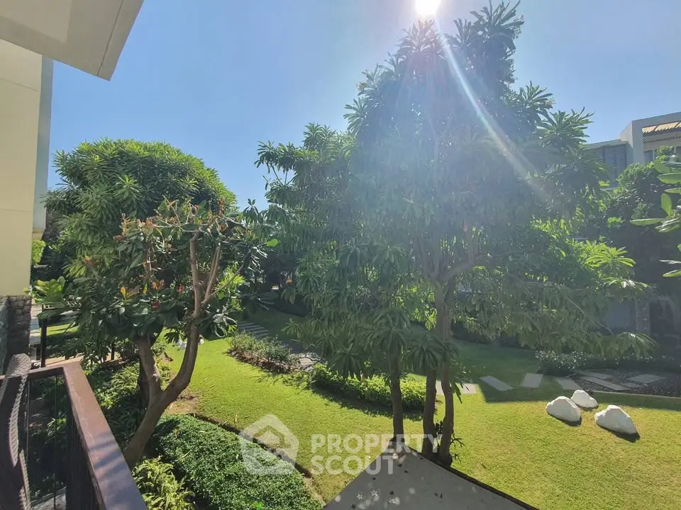 Lush garden view from a balcony in a modern residential complex