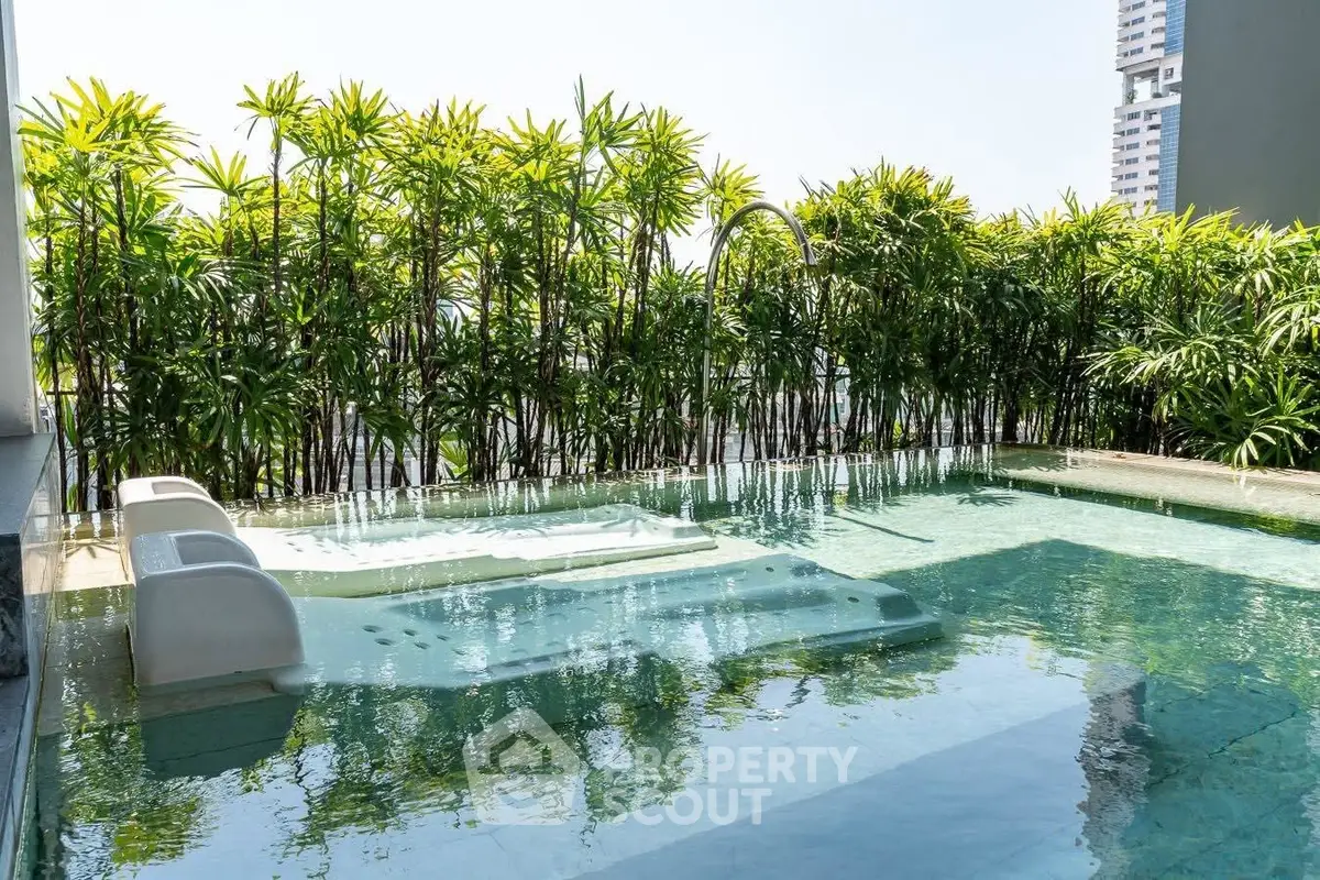 Luxurious rooftop pool with lush greenery and city views, perfect for relaxation and leisure.