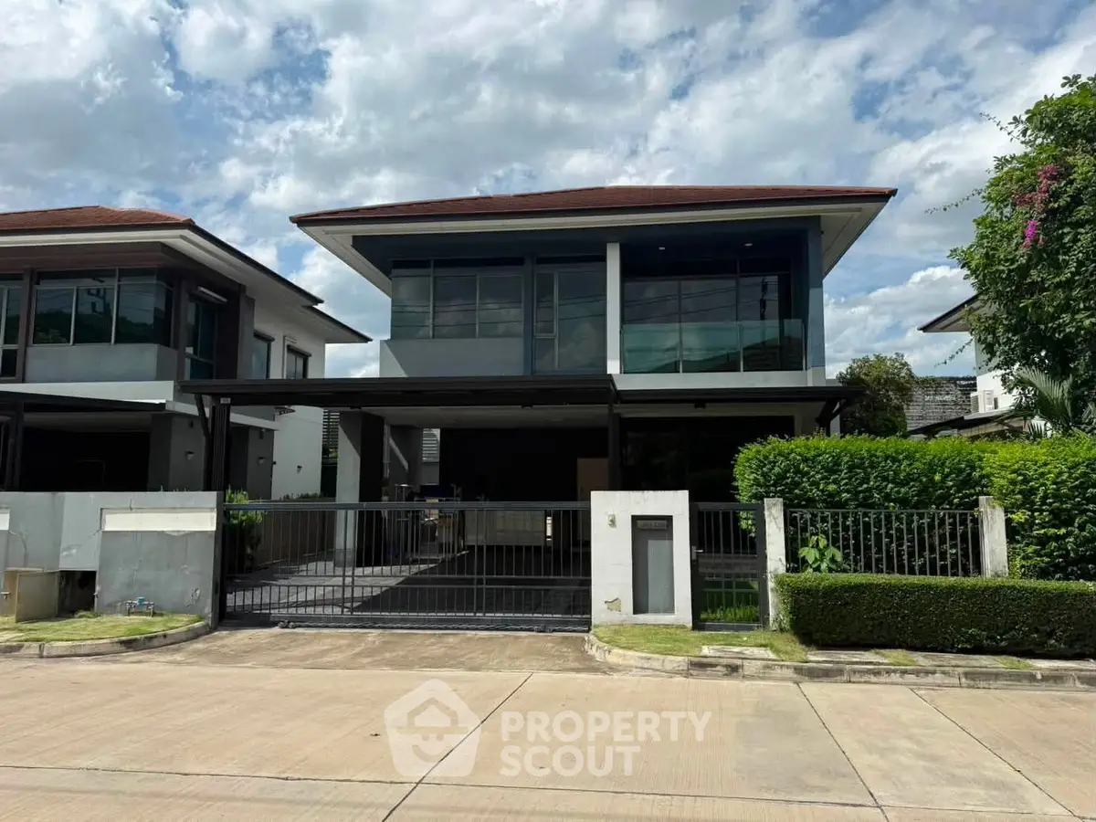 Modern two-story house with sleek design and spacious driveway in a serene neighborhood.