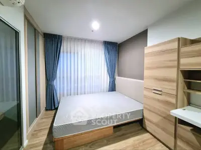 Modern bedroom with wooden furniture and large window with blue curtains