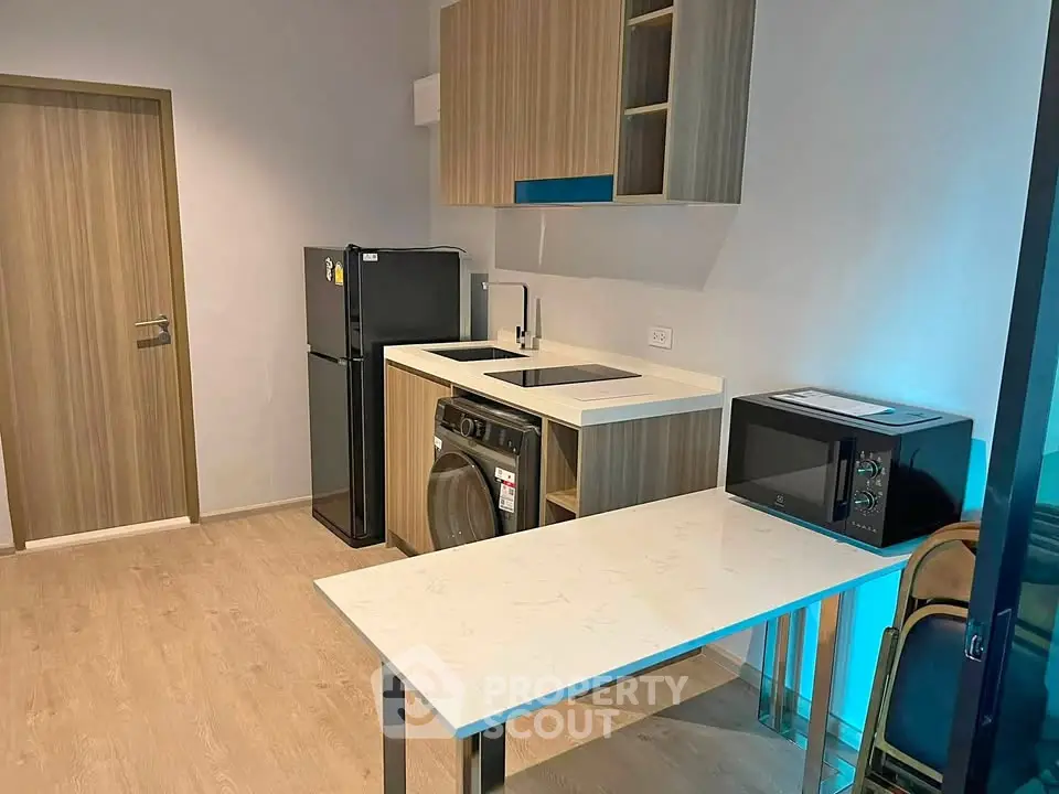 Modern compact kitchen with sleek appliances and stylish cabinetry