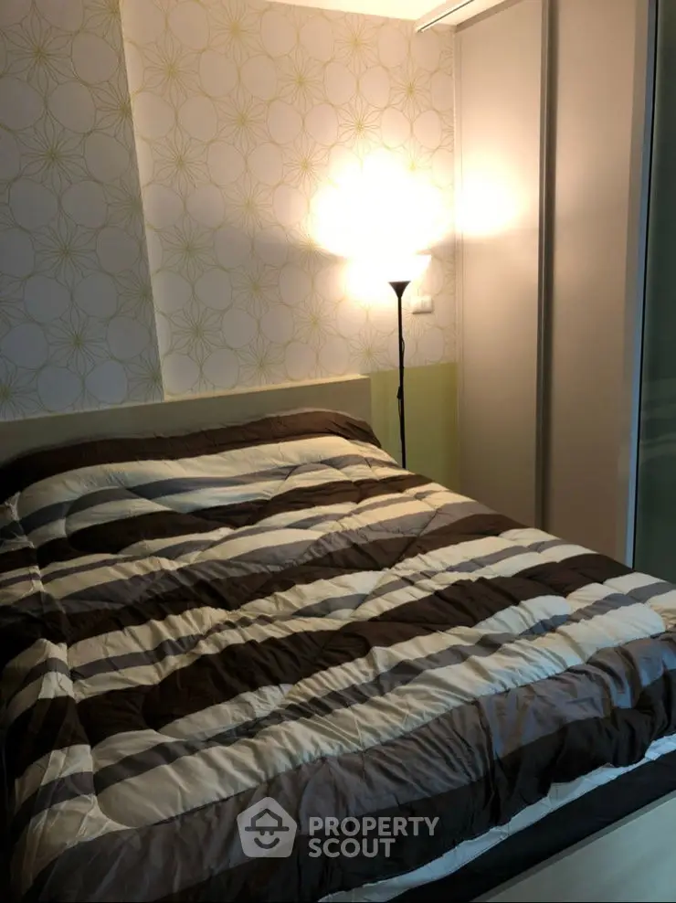 Cozy bedroom with modern decor and ambient lighting, featuring a stylish bed and elegant wallpaper.