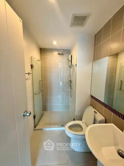 Modern bathroom with glass shower and sleek fixtures