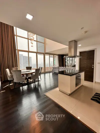Luxurious open-plan living and dining area with stunning city views and modern kitchen.