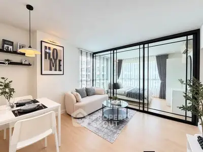 Modern open-plan living room with glass partition and stylish decor