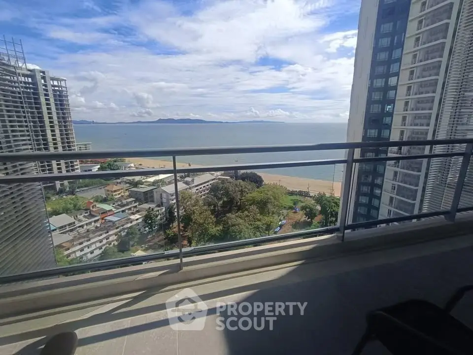 Stunning ocean view from high-rise balcony in modern urban setting.