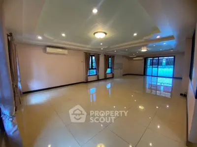 Spacious living room with elegant ceiling design and large windows
