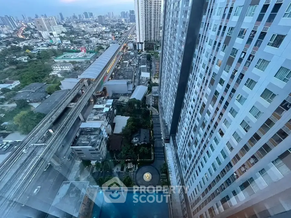 Stunning high-rise building view with cityscape and pool, perfect for urban living.