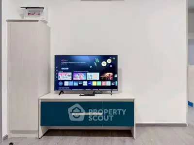 Modern living room with sleek TV stand and flat-screen TV, perfect for entertainment and relaxation.