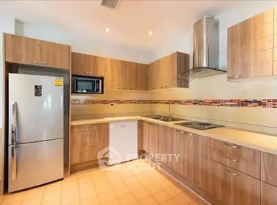 Modern kitchen with wooden cabinets and stainless steel appliances