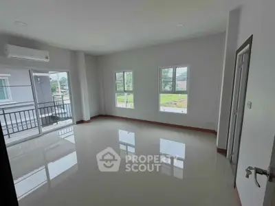 Spacious unfurnished room with large windows and balcony access, perfect for customization.