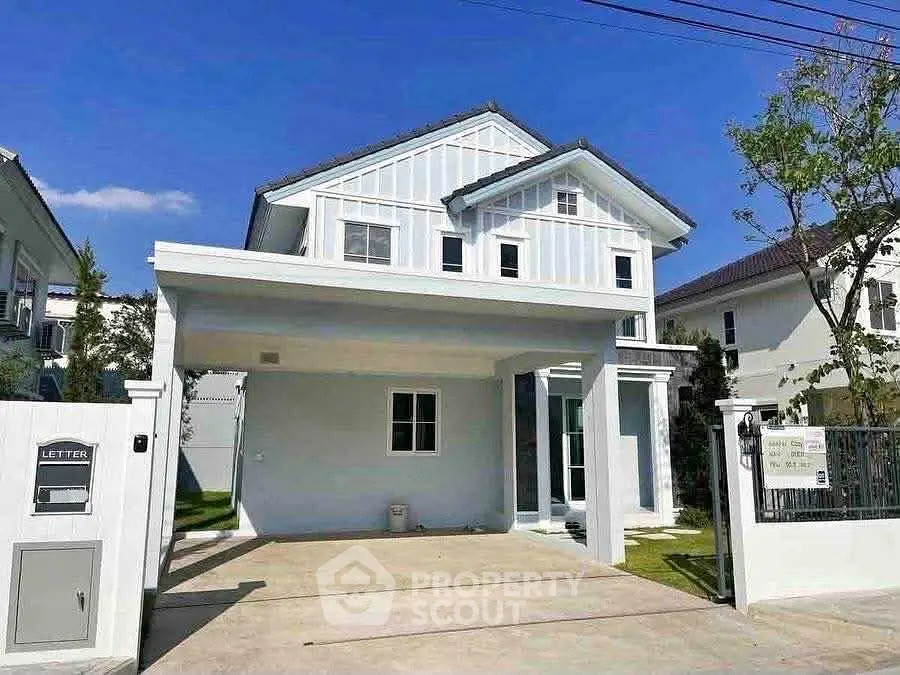 Charming two-story house with modern design and spacious driveway in a serene neighborhood.