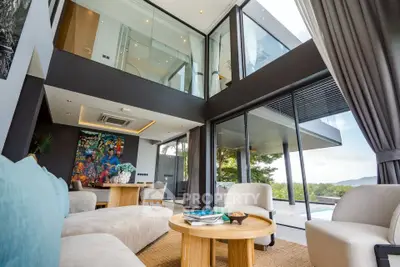 Luxurious modern living room with floor-to-ceiling windows and stunning outdoor view
