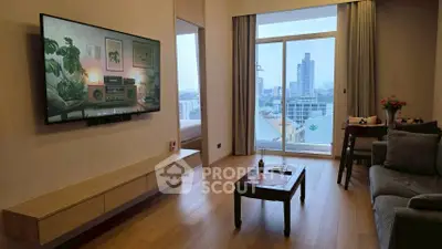 Modern living room with city view, stylish decor, and large TV