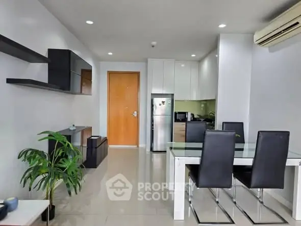 Modern dining area with sleek furniture and open kitchen layout
