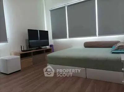 Modern bedroom with sleek design and large windows for natural light.