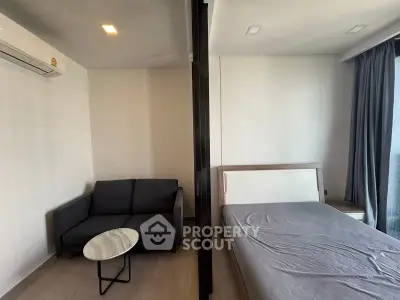 Modern studio apartment with cozy living area and comfortable bed, perfect for urban living.