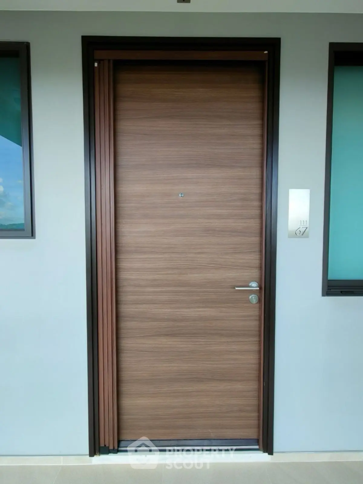 Modern wooden apartment entrance door with sleek design and secure lock system.