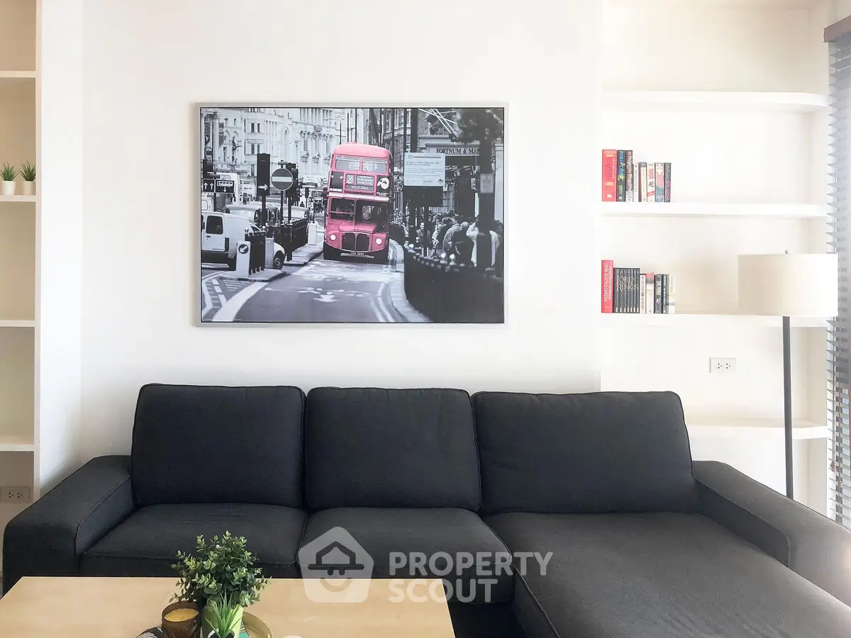 Modern living room with stylish black sofa and London-themed wall art, perfect for urban living.