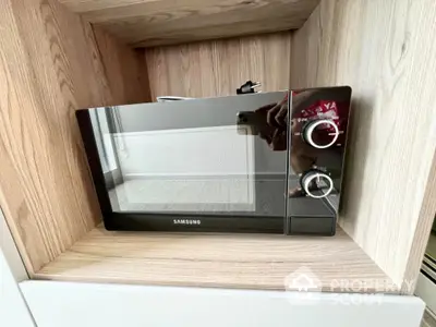 Modern kitchen with sleek Samsung microwave in wooden cabinetry