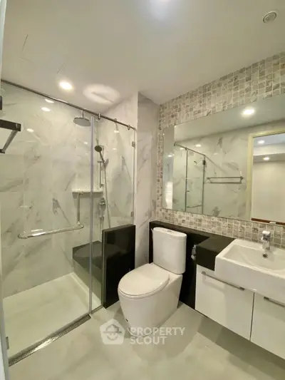Modern bathroom with glass shower and sleek fixtures