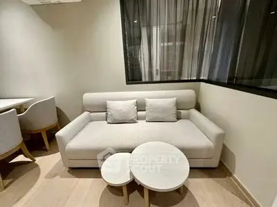 Modern living room with stylish sofa and nested coffee tables in a cozy setting.