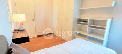 Cozy bedroom with modern furnishings and ample storage space