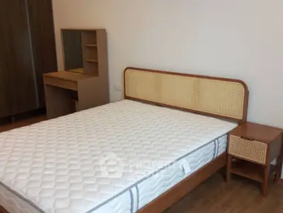 Spacious bedroom with modern wooden furniture and comfortable mattress.