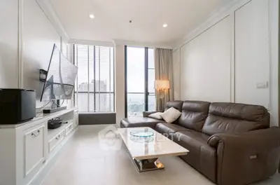 Luxurious living room with leather sofa and large TV in modern apartment