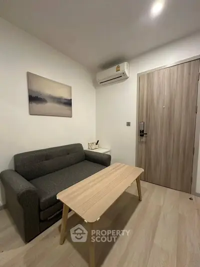 Cozy living room with modern sofa and wooden coffee table, perfect for relaxation.