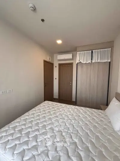 Cozy bedroom with a comfortable mattress and built-in wardrobe, perfect for restful nights.