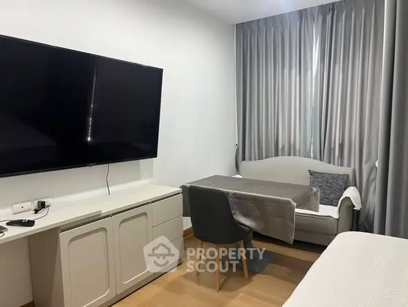 Modern living room with sleek TV setup and cozy seating area