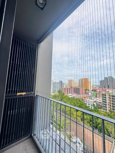 Modern balcony with city view and safety netting in high-rise apartment