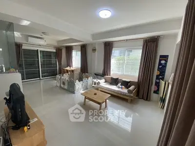 Spacious living room with modern decor and large windows for natural light.