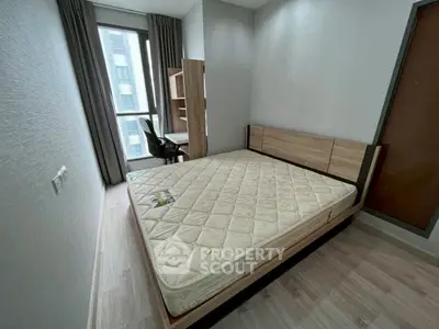 Modern bedroom with large window and minimalist furniture