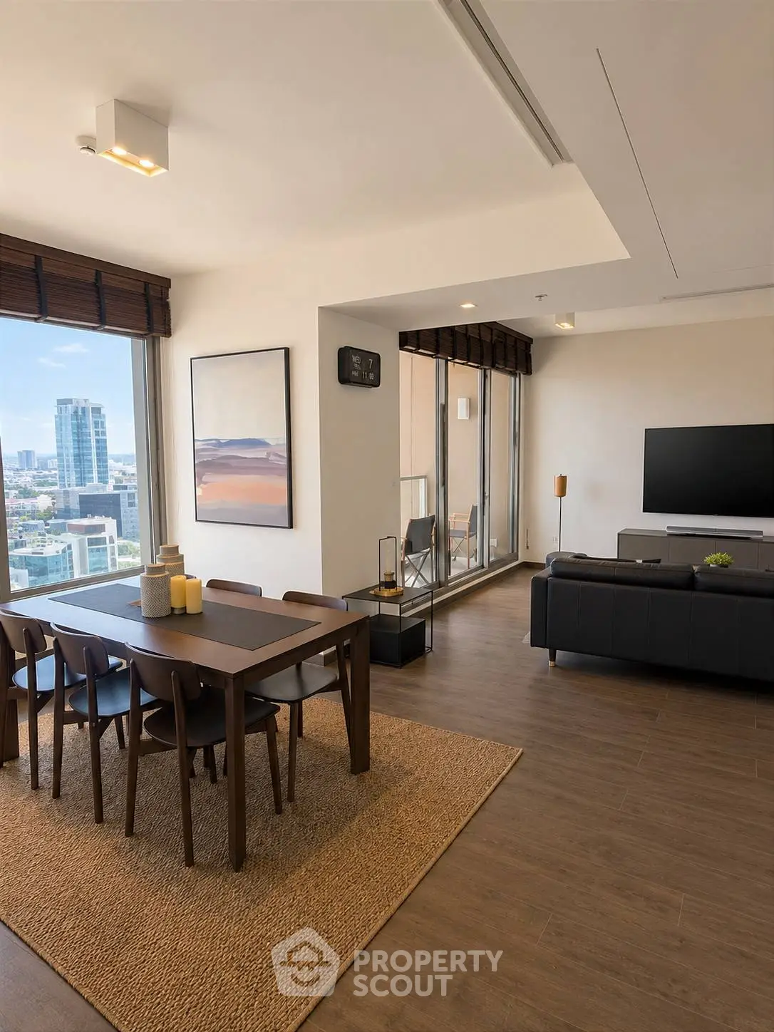Modern open-plan living and dining area with city view, featuring sleek furniture and large windows.