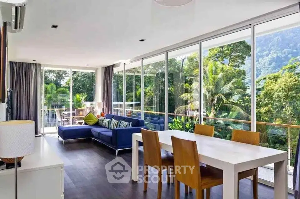 Spacious living room with large windows and stunning forest view