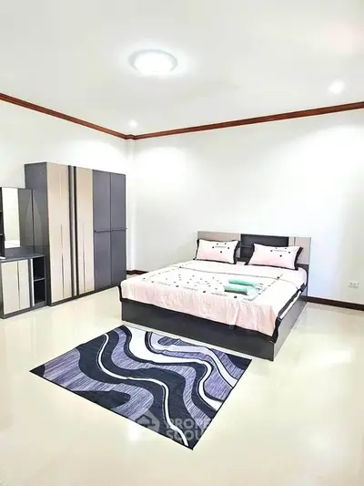 Spacious modern bedroom with stylish decor and ample storage space