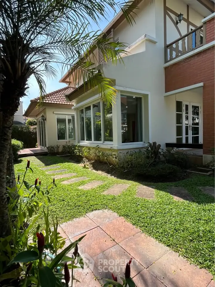 Charming suburban home with lush garden and large windows, perfect for natural light lovers.