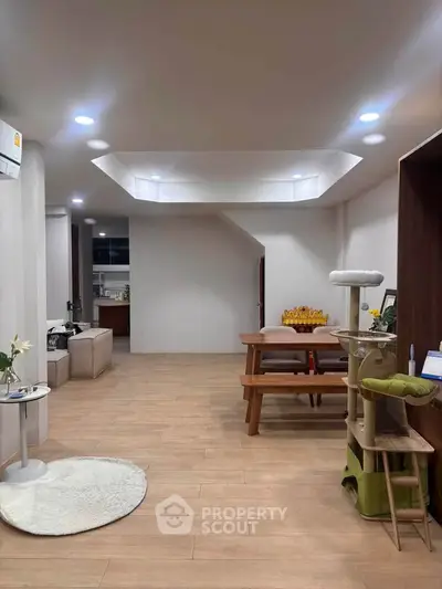 Spacious modern living room with wooden flooring and stylish furniture, perfect for family gatherings.