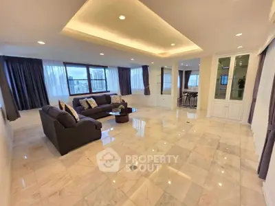 Spacious and elegant living room with marble flooring and city view, perfect for luxury living.