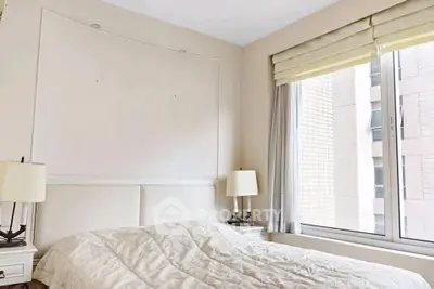 Bright and cozy bedroom with large window and elegant decor