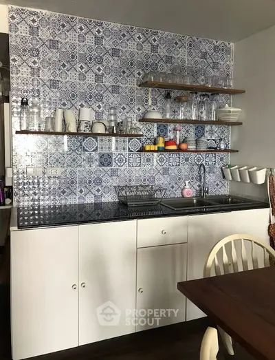 Charming kitchen with patterned tile backsplash and open shelving