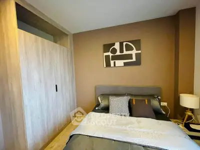 Modern bedroom with stylish decor and cozy bedding in a contemporary apartment.