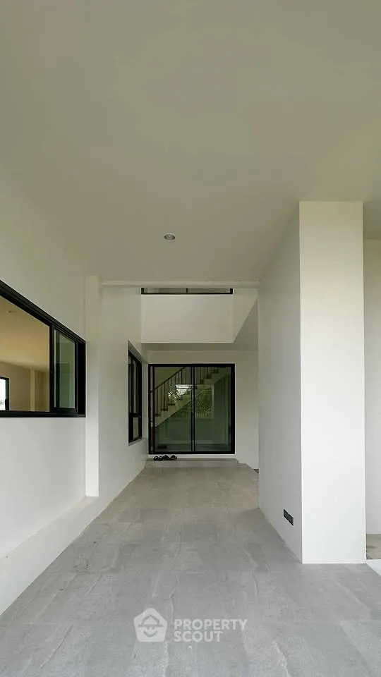 Modern minimalist entrance with sleek design and large windows