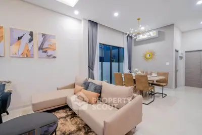 Modern living room with stylish decor and dining area, featuring elegant lighting and contemporary furniture.