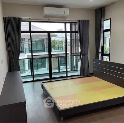 Spacious bedroom with large windows and modern design in a luxury home