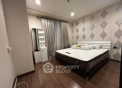 Modern bedroom with stylish wallpaper and wooden flooring