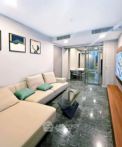 Modern living room with sleek design and comfortable seating in a stylish apartment.