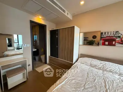 Modern bedroom with ensuite bathroom and stylish furniture in a cozy apartment.